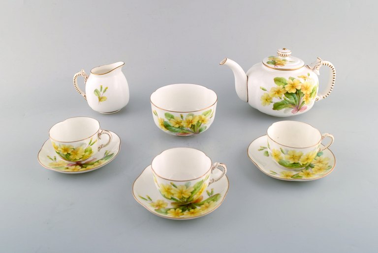 Royal Worchester tea set in hand-painted porcelain. Complete for four people 
with sugar bowl and creamer. Decorated with yellow flowers. 1920 / 30