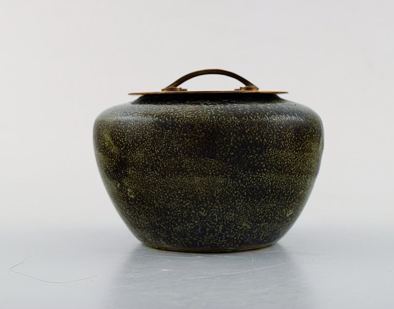 Patrick Nordstrøm / Carl Halier for Royal Copenhagen. Stoneware jar decorated 
with olive glaze and bronze lid. 1930