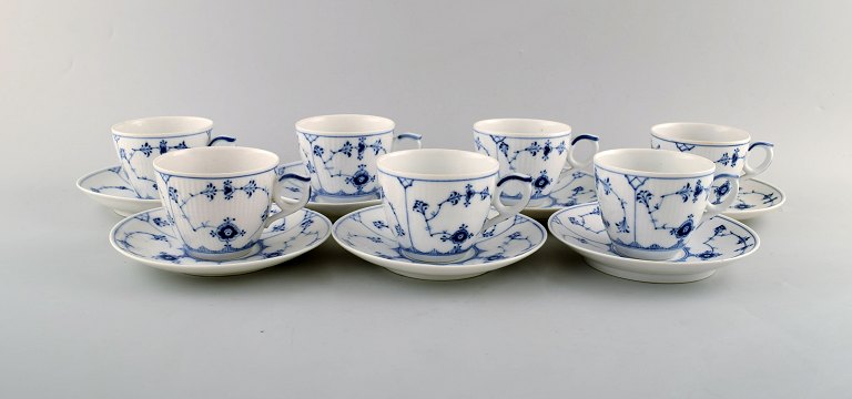Royal Copenhagen. Set of seven Blue Fluted plain coffee cup with saucer # 1/79.