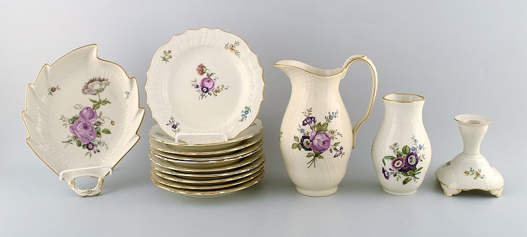 Royal Copenhagen. "Frisenborg". Ten plates, two jugs, candlestick and a leaf 
shaped dish.