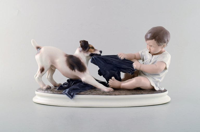 Large Dahl Jensen porcelain figurine. Boy and dog. Model number 1072. 2nd 
factory quality. 1930