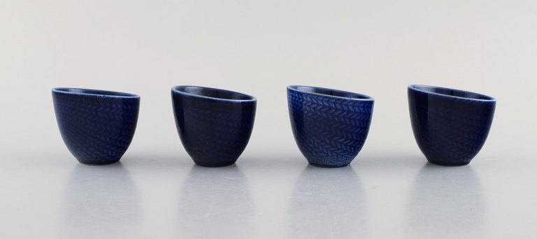 Hertha Bengtson for Rörstrand. Four "blå eld" porcelain egg cups. 1960