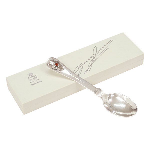 A sterlingsilver Georg Jensen 75 years anniversary spoon. L: 15cm