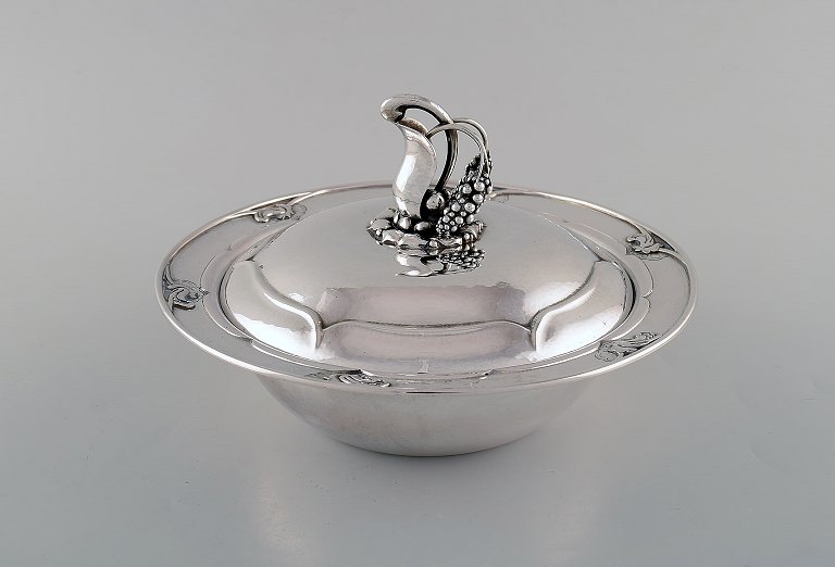 Early and rare art nouveau Georg Jensen lidded bowl in hammered silver. knob in 
the form of foliage. Model Number 228. Designed by Georg Jensen. Dated 1915-30.
