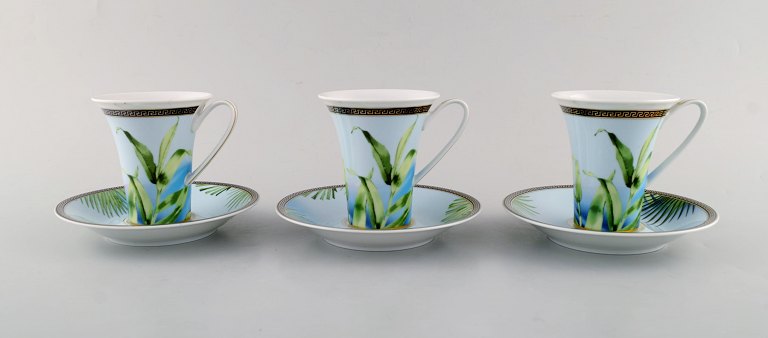 Gianni Versace for Rosenthal. Three "Jungle" coffee cups with saucer in 
porcelain with gold decoration and green leaves. Late 20th century.
