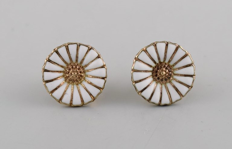 Georg Jensen earrings in gold-plated sterling silver with white enamel daisies. 
Late 20th century.
