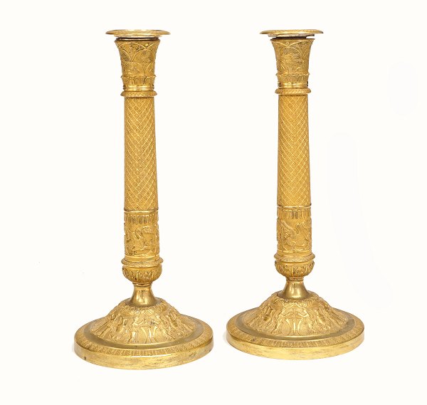 A pair of early 19th century gilt candlesticks. France circa 1810-20. H: 32cm