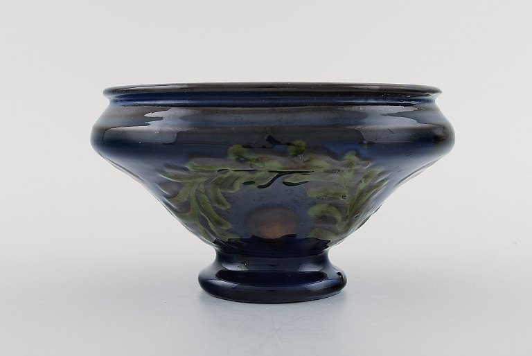 Kähler, Denmark. Bowl in glazed ceramics. Green leaves and red berries on a dark 
blue background. 1930 / 40s.
