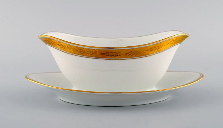 Royal Copenhagen stel nr. 607, White. Porcelain sauce boat with gold edge. Model 
number 607/9344.
