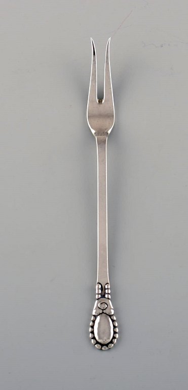 Evald Nielsen number 13 cold meat fork in hammered silver (830). 1920s.
