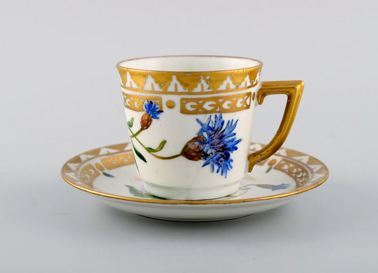 Royal Copenhagen coffee cup with saucer in hand-painted porcelain with gold 
decoration and flowers. Flora danica style, 1960s.
