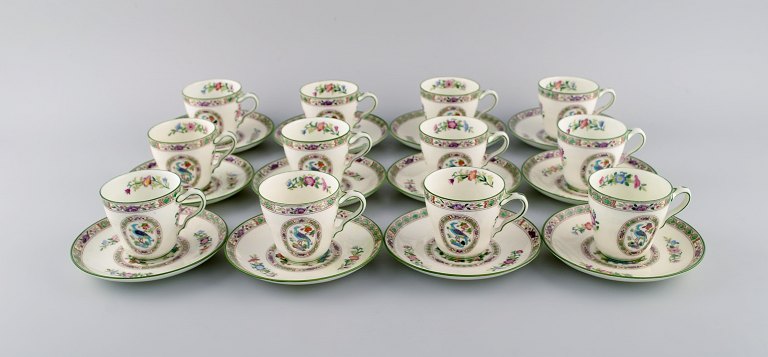 Wedgwood, England. Coffee service for 12 people in hand-painted porcelain with 
flower decoration and birds. About 1930.
