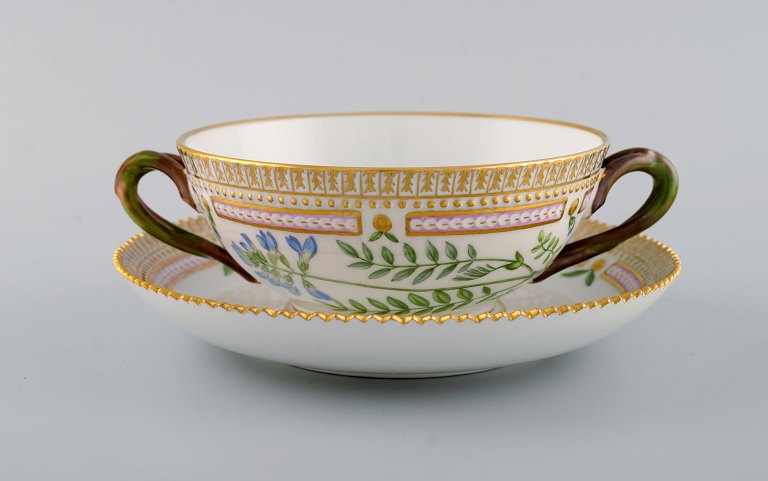 Royal Copenhagen Flora Danica boullion cup with saucer in hand-painted porcelain 
with branch-shaped handles, flowers and gold decoration. Model number 20/3612.
