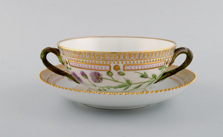 Royal Copenhagen Flora Danica boullion cup with saucer in hand-painted porcelain 
with branch-shaped handles, flowers and gold decoration. Model number 20/3612.
