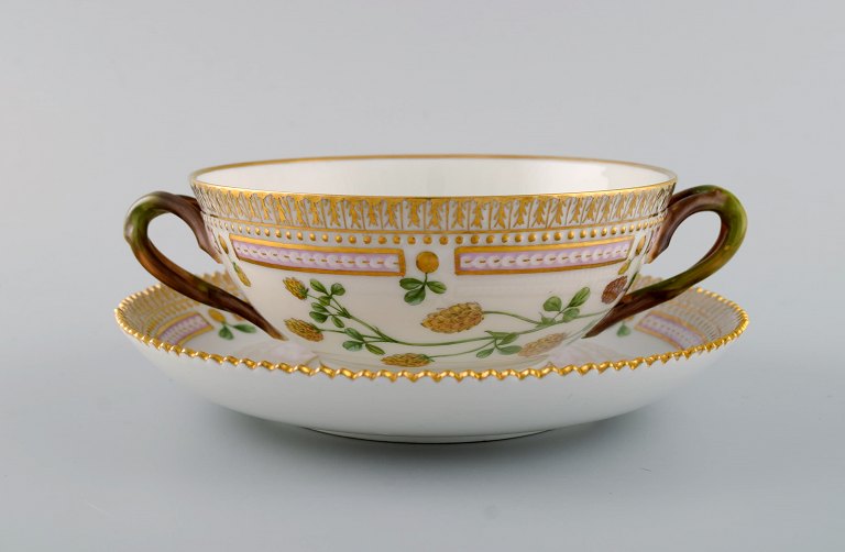 Royal Copenhagen Flora Danica boullion cup with saucer in hand-painted porcelain 
with branch-shaped handles, flowers and gold decoration. Model number 20/3612.
