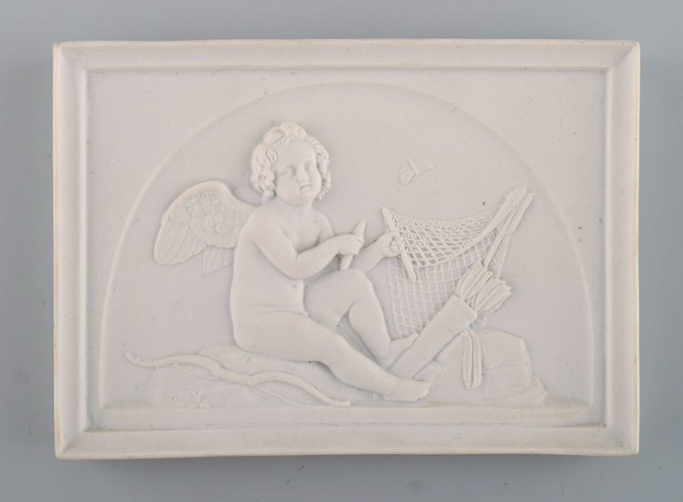 Royal Copenhagen after Thorvaldsen. Antique biscuit wall plaque. Amor. Late 19th 
century.
