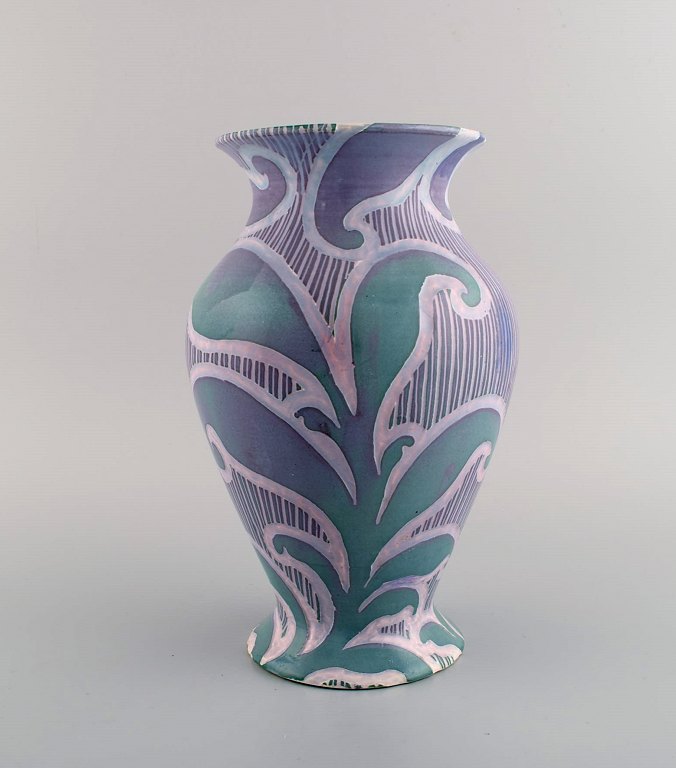 Gunnar Wennerberg for Gustavsberg. Antique unique art nouveau vase in glazed 
ceramics. Beautiful glaze in purple shades with foliage in relief. Dated 1902.
