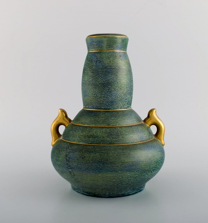 Josef Ekberg for Gustavsberg. Art deco vase with handles in glazed ceramics. 
Beautiful blue-green glaze and gold decoration. 1930s.
