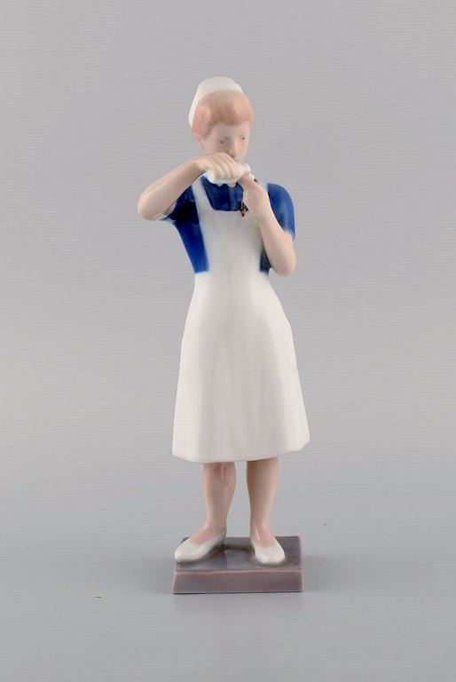Rare Bing & Grøndahl porcelain figurine. Nurse. Model number 2379. Mid 20th 
century.
