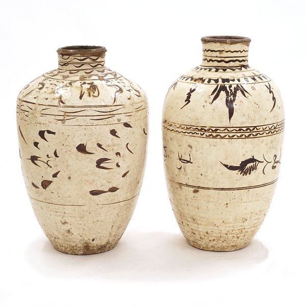 A pair of large cream glazed Citzhou Jars. China circa 1700-50. H: 68 & 73cm