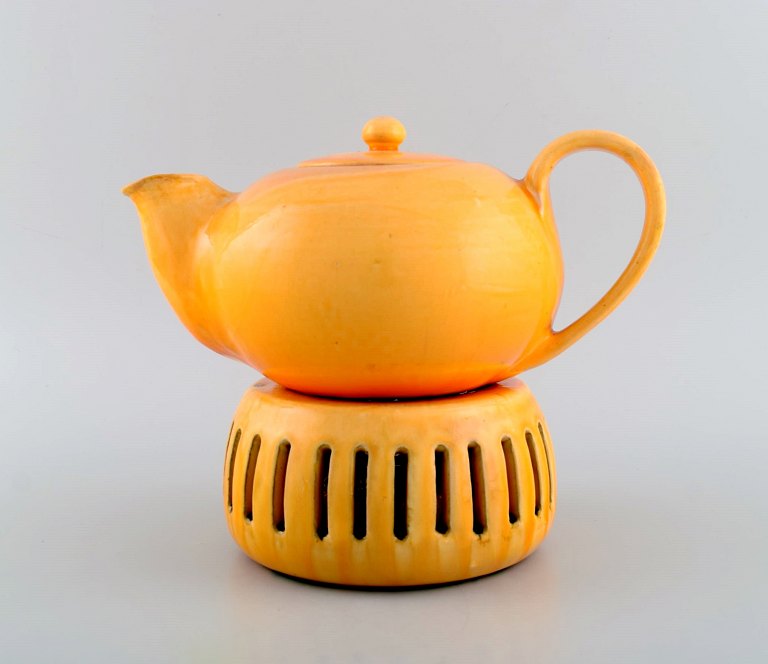 Kähler, Denmark. Teapot with heater for tealights in glazed stoneware. Beautiful 
orange uranium glaze. 1930s / 40s.
