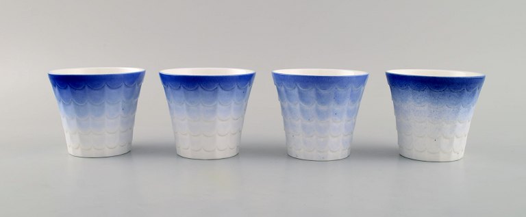 Wilhelm Kåge for Gustavsberg. Four flower pot covers in porcelain. Swedish 
design, 1960s.
