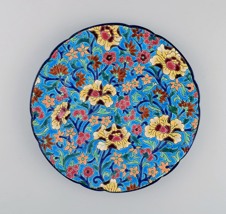 Longwy, France. Art deco plate in glazed stoneware with hand-painted flowers and 
foliage. 1920s / 30s.
