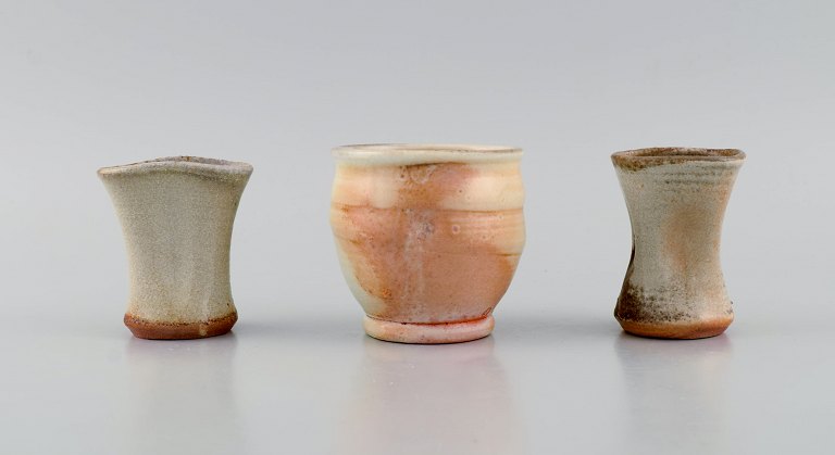 Danish studio ceramicist. Three unique vases in glazed stoneware. Beautiful 
glazes in peach and light earth shades. Late 20th century.
