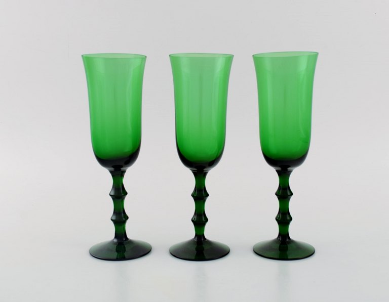 Simon Gate for Orrefors. Three Salut champagne glasses in green mouth blown art 
glass. Swedish design, 1920s / 30s.
