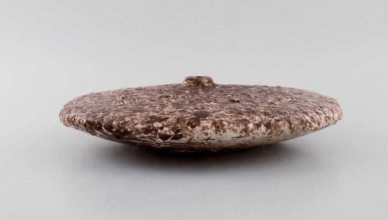European studio ceramicist. Unique disc shaped vase in glazed stoneware. Dated 
1975.
