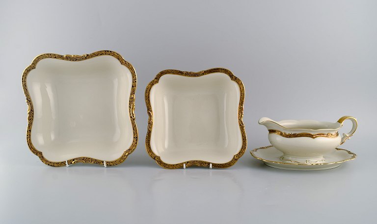 KPM, Berlin. Royal Ivory sauce boat and two bowls in cream-colored porcelain 
with gold decoration. 1920s.
