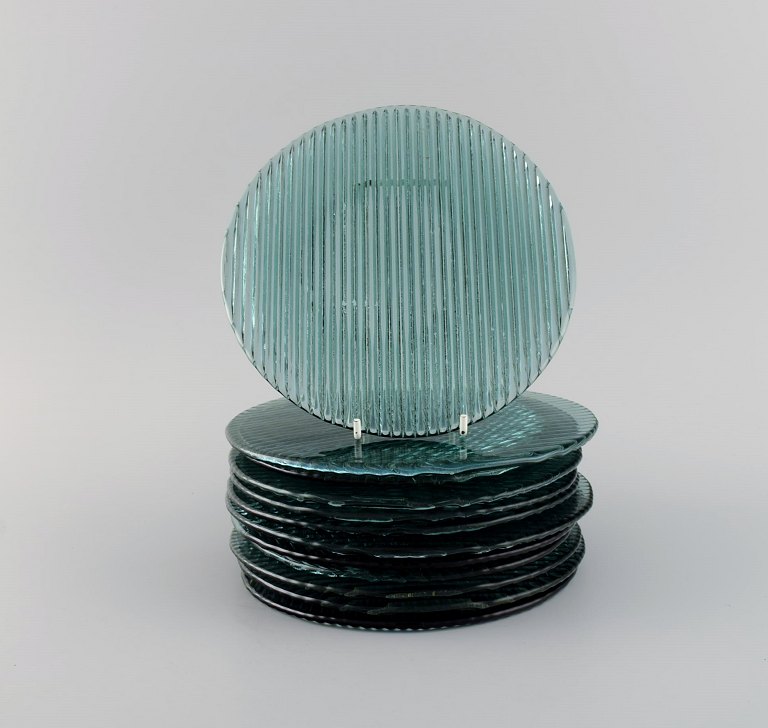 Per Lütken for Holmegaard. Twelve "Buffet" plates in blue-green mouth blown art 
glass. 1980s.
