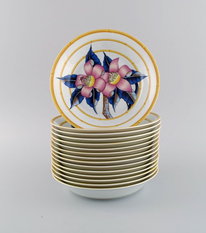 Porcelaine de Paris. "Aurore Tropicale". 15 deep porcelain plates decorated with 
flowers and bamboo. 1980s.
