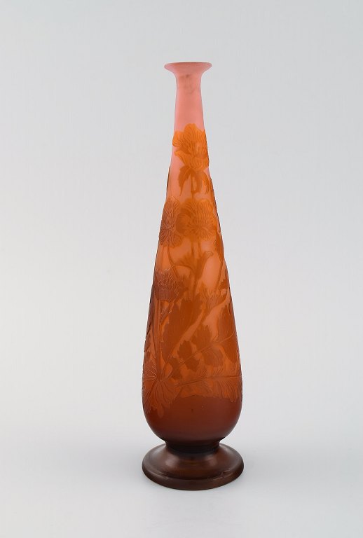 Emile Gallé vase in frosted and orange art glass carved in the form of flowers 
and foliage. Early 20th century.
