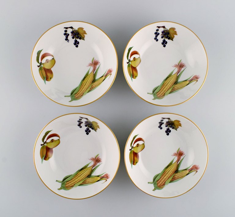 Royal Worcester, England. Four Evesham porcelain bowls decorated with fruits and 
gold rim. 1980s.
