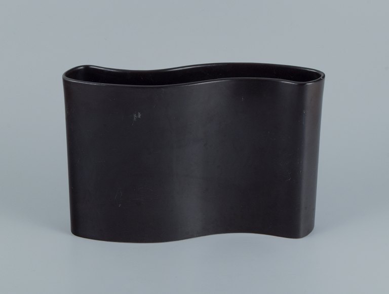 European studio ceramicist. Large wavy ceramic vase in black glaze.