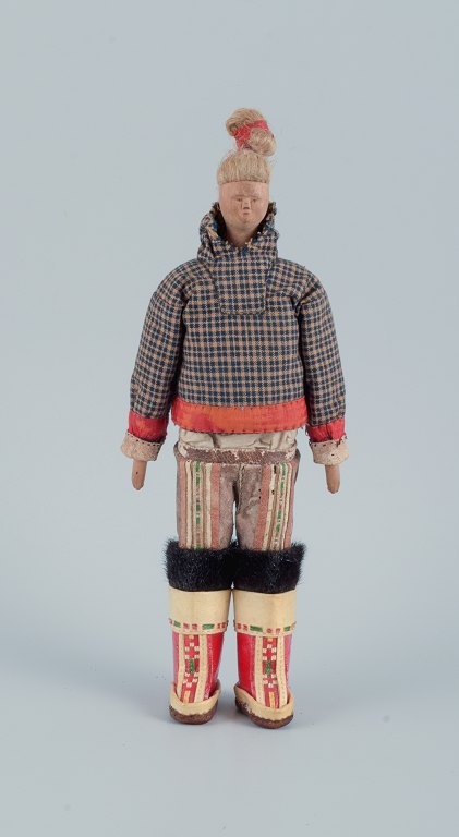 Greenlandica. Woman wearing Greenlandic dress. Made of wood and fabric.