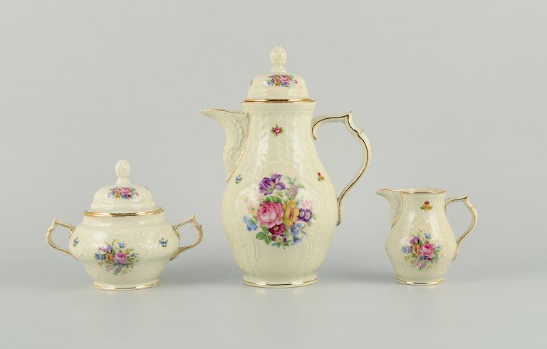 Rosenthal, Germany. "Sanssouci" Coffee pot, sugar bowl and creamer decorated 
with flowers and gold.