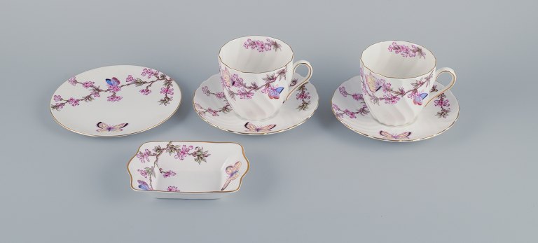 Tuscan, England, Bone China. Two pairs of large coffee cups, a plate and a small 
bowl decorated with butterflies and cherry blossoms.