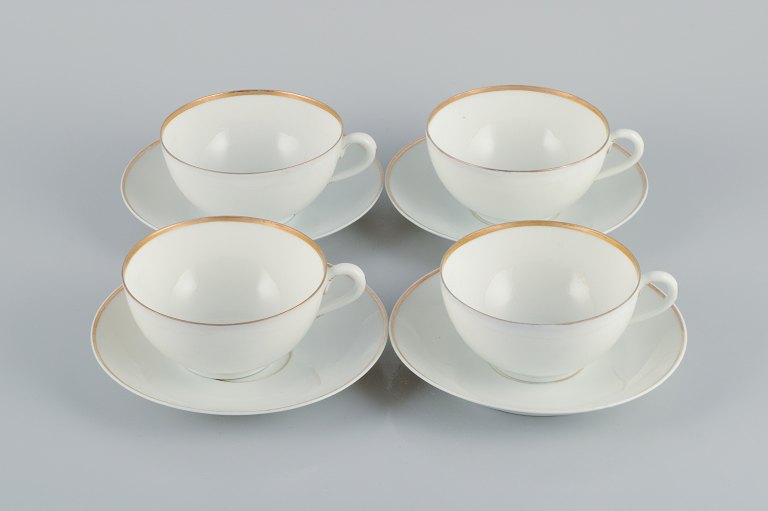 Rosenthal, Germany, a set of four large teacups and matching porcelain saucers. 
Thin white porcelain with gold decoration.