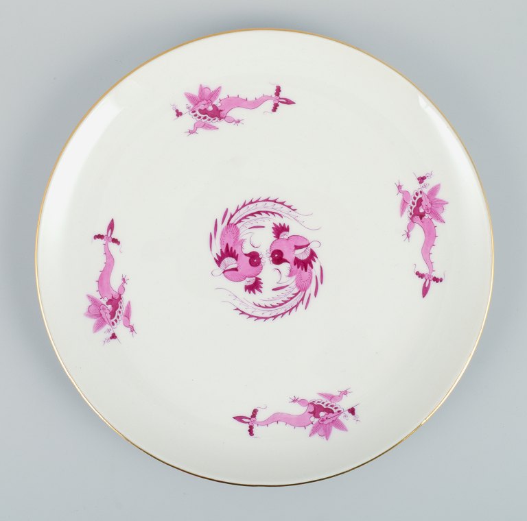 Meissen, Germany, Rich Court Dragon, round dish in purple with gold decoration. 
Hand painted.