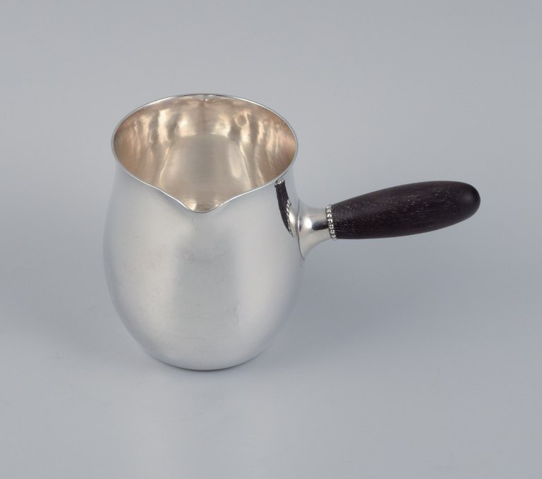 Georg Jensen Art Nouveau milk jug in sterling silver with ebony handle.