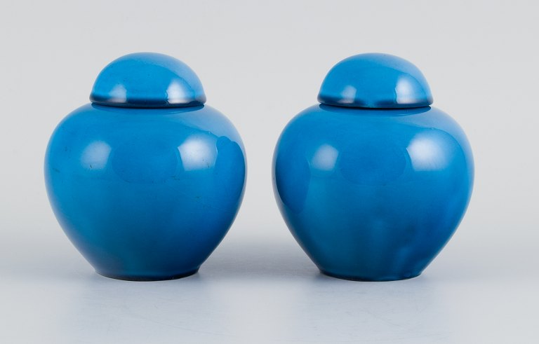 French ceramicist, a pair of lidded jars in turquoise glaze.