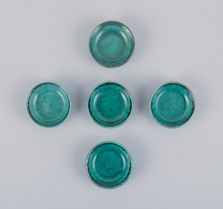 Wilhelm Kåge for Gustavsberg, a set of five small "Argenta" ceramic bowls. Green 
glaze with silver inlays.