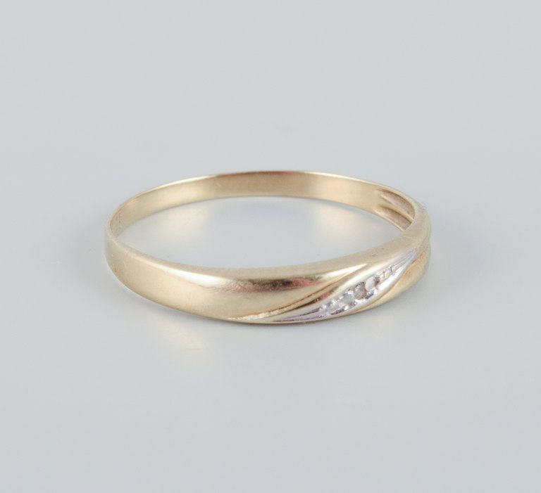 8 karat gold ring adorned with small diamonds. Modernist design.