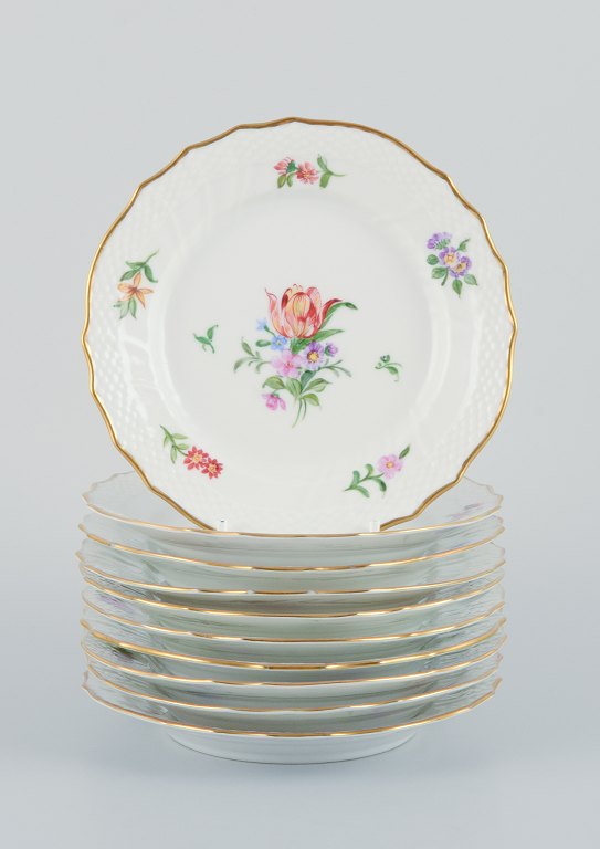 Royal Copenhagen, Saxon Flower, a set of ten small plates hand-decorated with 
polychrome flowers and gold rim.