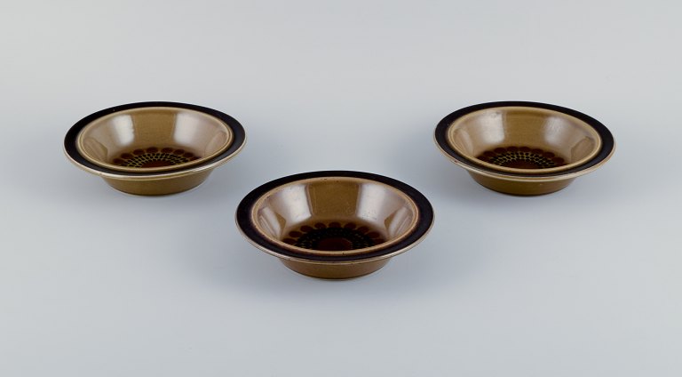 Gunvor Olin-Grönqvist for Arabia, "Cosmos," three deep plates. Stoneware in a 
retro style. Glazed in green-brown tones.