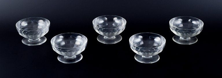 Baccarat, France, a set of five "Charmes" Art Deco champagne coupes in clear 
crystal glass. Faceted cut.