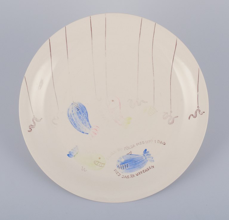 Stig Lindberg for Gustavsberg. "Löja" plate. Hand-painted with a fish motif. 
Satirical illustration with Swedish text.