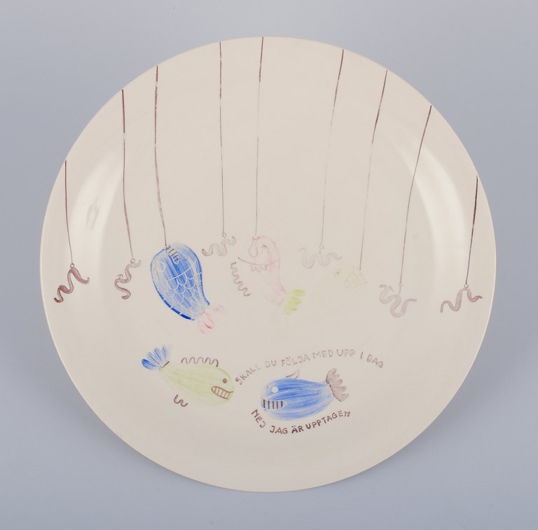 Stig Lindberg for Gustavsberg. "Löja" plate. Hand-painted with a fish motif. 
Satirical illustration with Swedish text.